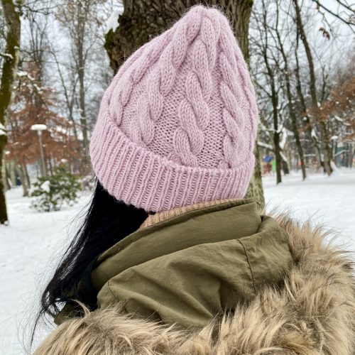 Me wearing a pink hat with a winter landscape