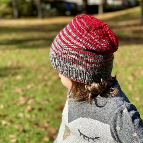 Slouchy version of the William's Hat featuring gradient stripes in Red and Gray, showcasing a modern and stylish design.