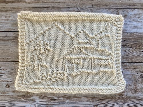 Finished Mountain Cabin Square in white on a wooden surface