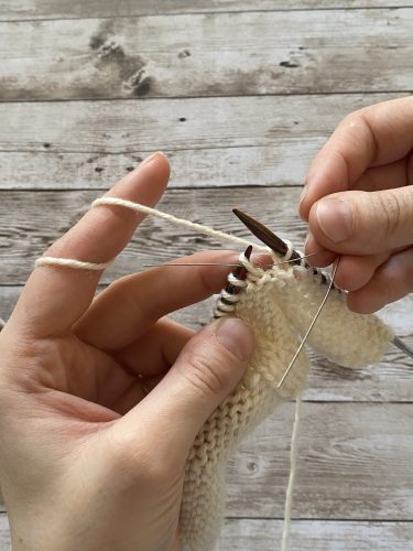 Step-by-step tutorial image demonstrating one of three techniques for threading beads onto yarn for knitting: using a hook, dental floss or thread, or pre-threading. The image shows the tools, materials, and process clearly to guide the viewer through the technique.