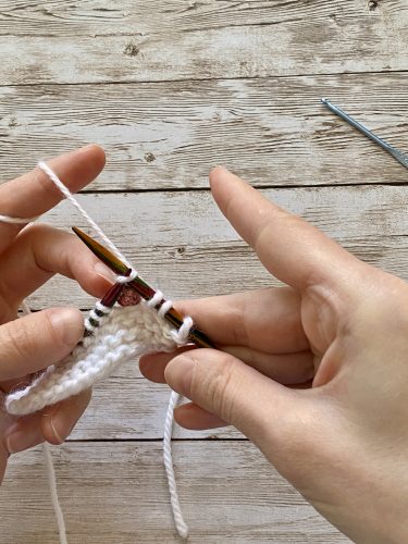 Step-by-step tutorial image demonstrating one of three techniques for threading beads onto yarn for knitting: using a hook, dental floss or thread, or pre-threading. The image shows the tools, materials, and process clearly to guide the viewer through the technique.