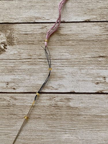 Step-by-step tutorial image demonstrating one of three techniques for threading beads onto yarn for knitting: using a hook, dental floss or thread, or pre-threading. The image shows the tools, materials, and process clearly to guide the viewer through the technique.