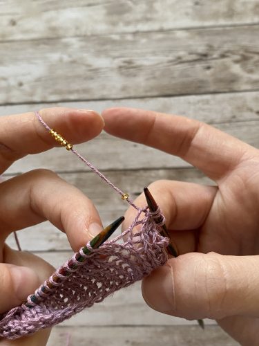 Step-by-step tutorial image demonstrating one of three techniques for threading beads onto yarn for knitting: using a hook, dental floss or thread, or pre-threading. The image shows the tools, materials, and process clearly to guide the viewer through the technique.