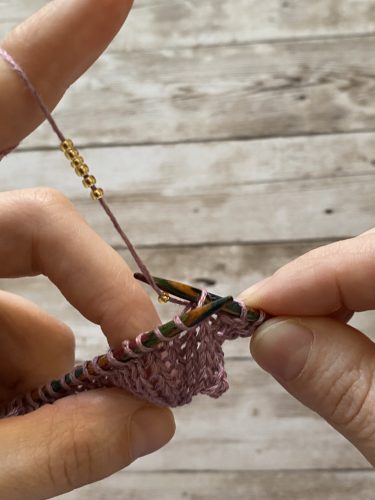 Step-by-step tutorial image demonstrating one of three techniques for threading beads onto yarn for knitting: using a hook, dental floss or thread, or pre-threading. The image shows the tools, materials, and process clearly to guide the viewer through the technique.