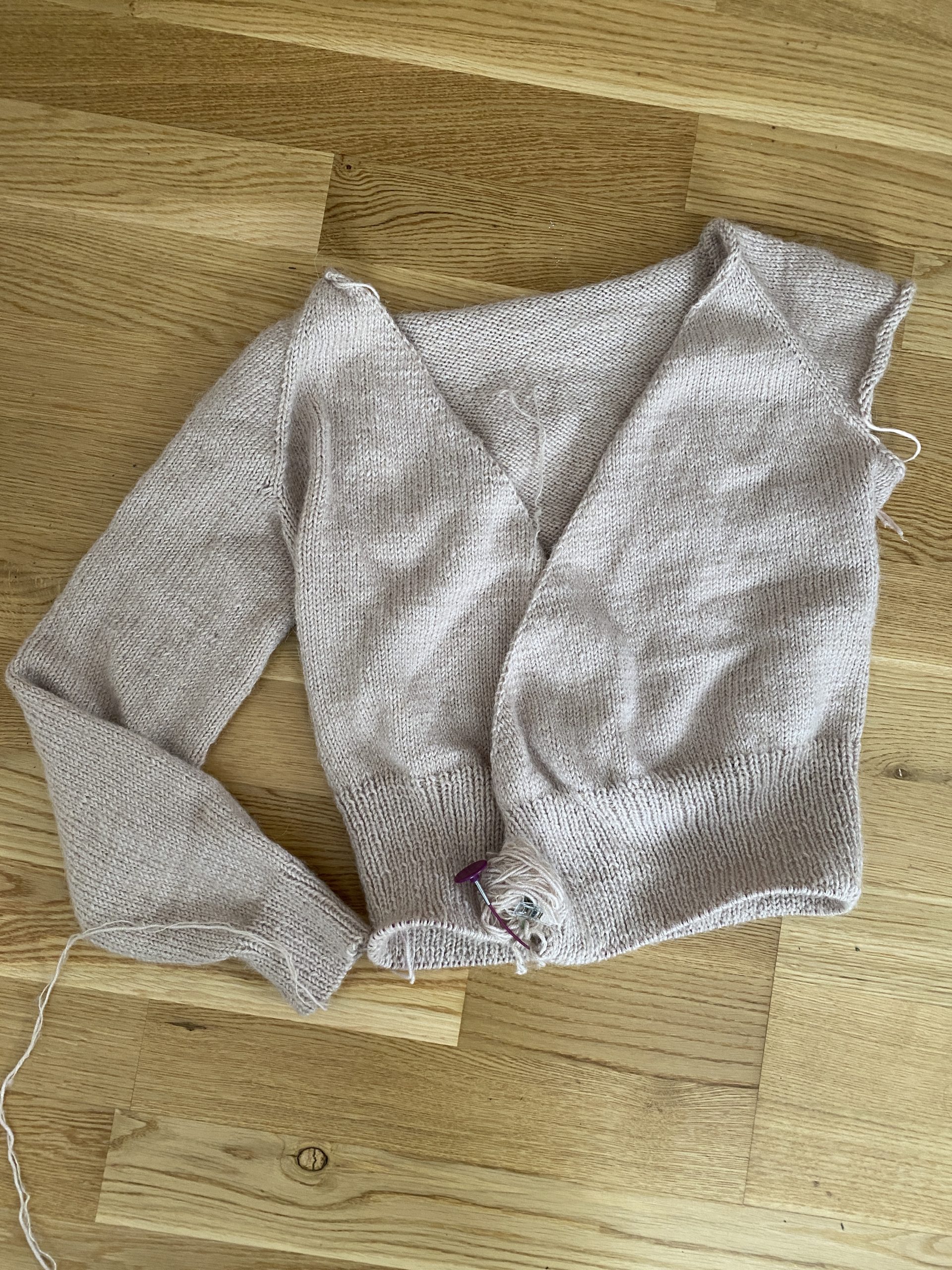 A partially completed Robinson Wrap Cardigan in a soft beige color