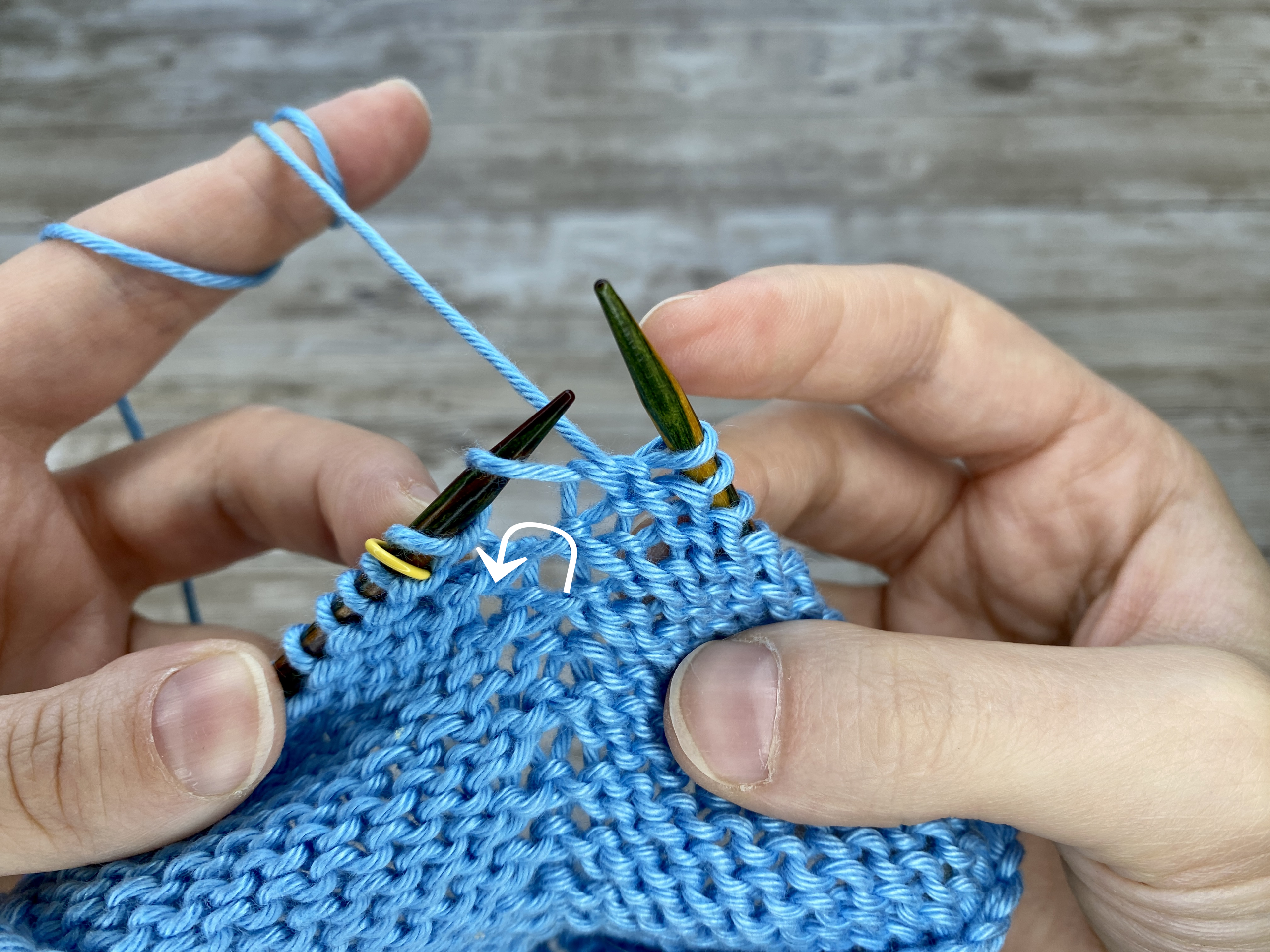Close-up of a knitted swatch with the 'Make One Left Purl' (M1LP) increase.