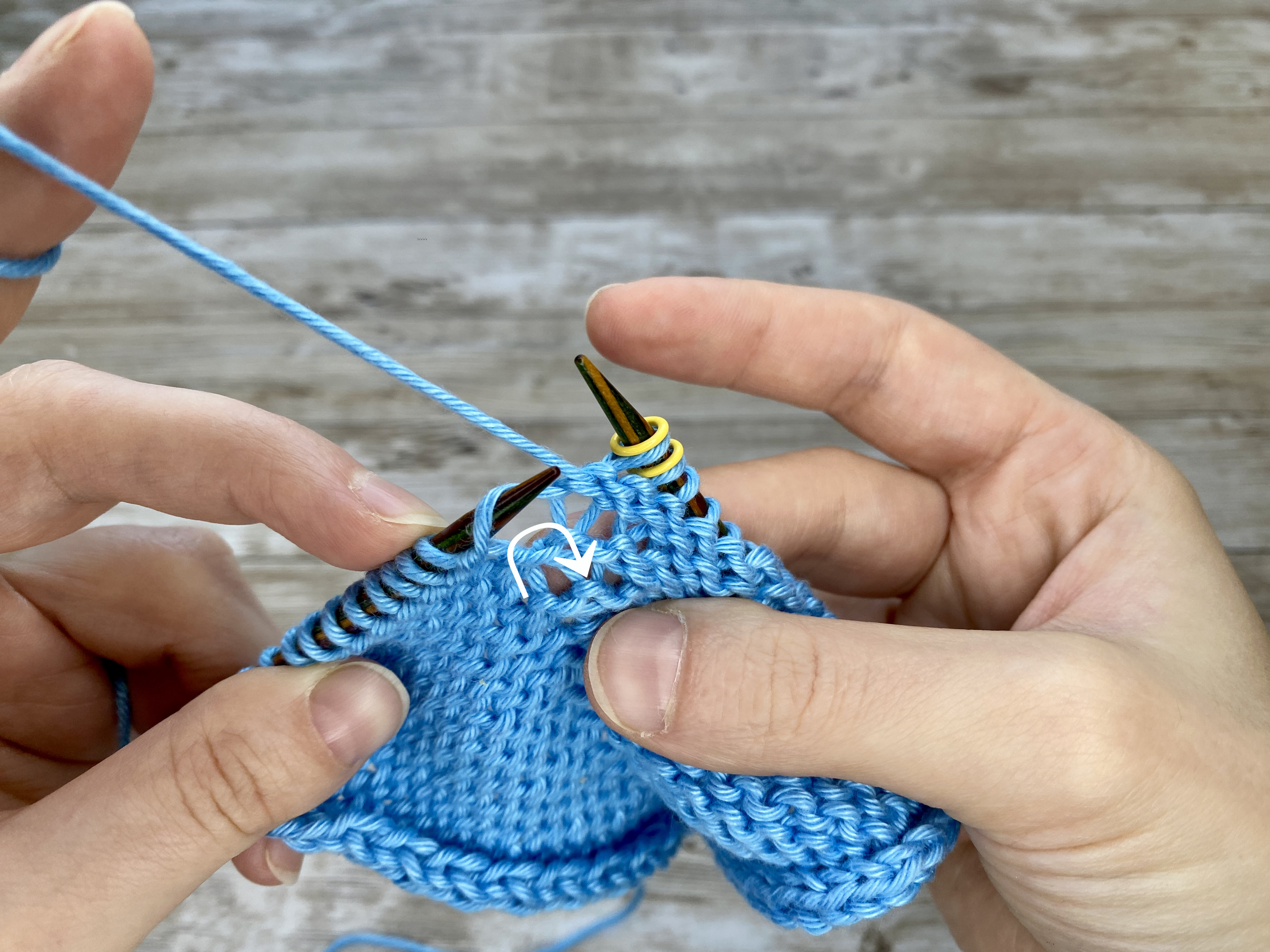 Close-up of a knitted swatch with the 'Make One Right Purl' (M1RP) increase.