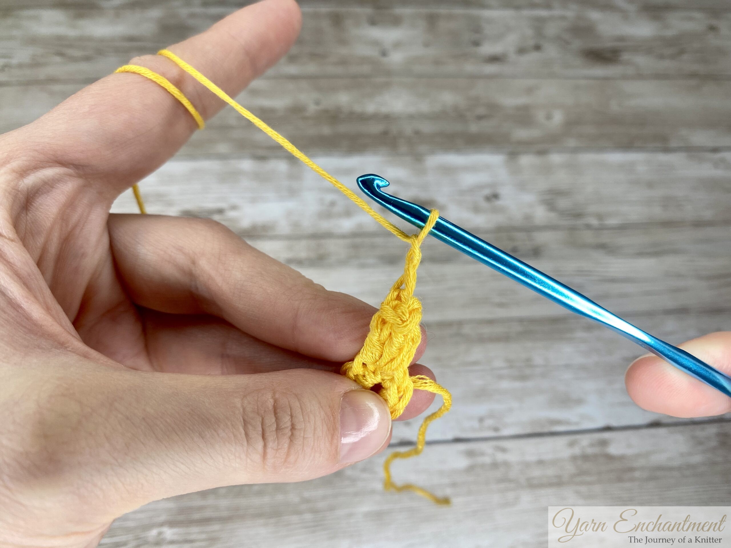 two chains crocheted after the slip stitch, securing the popcorn stitch