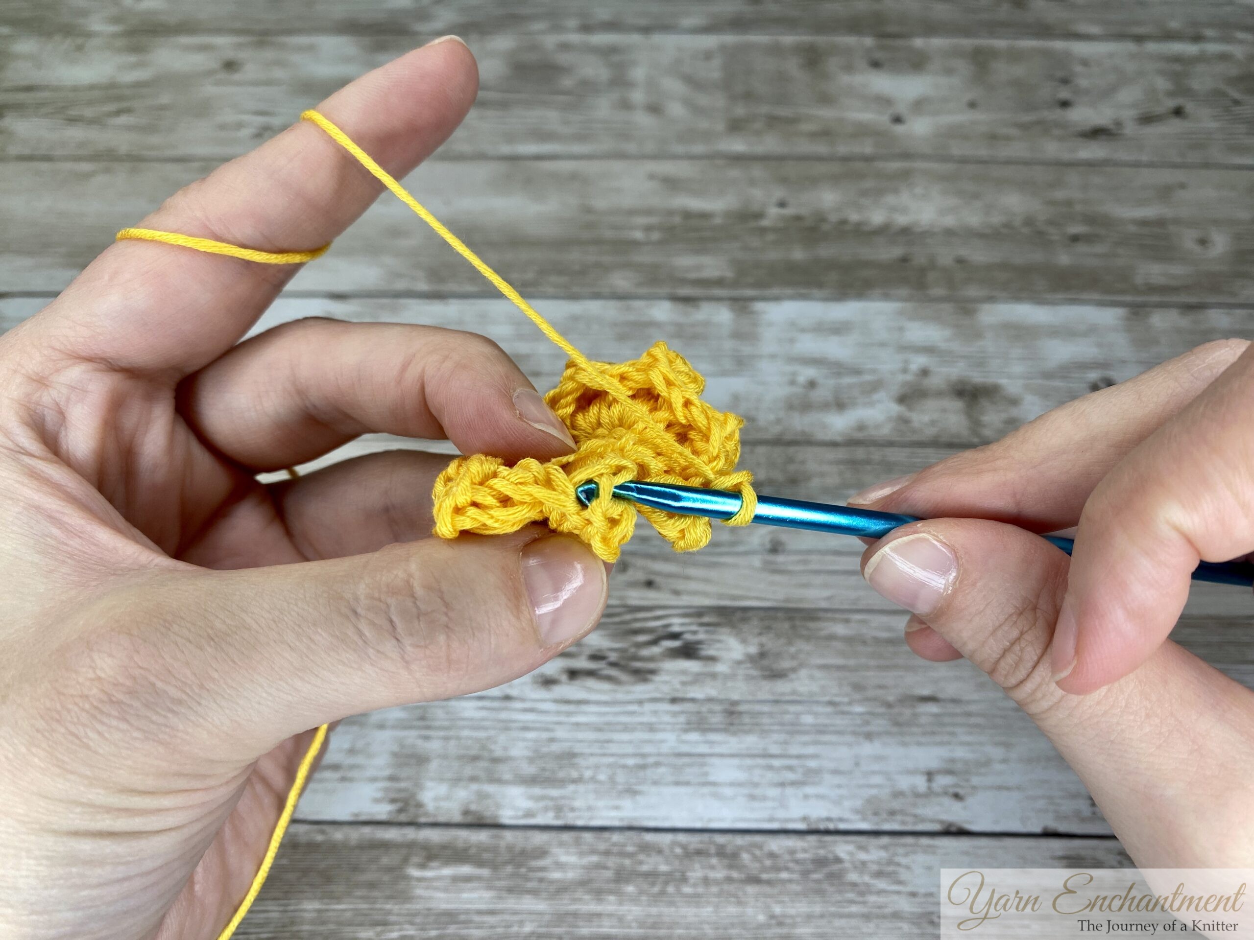Close-up of a 3D crochet flower granny square, showing the slip stitch used to close the round.