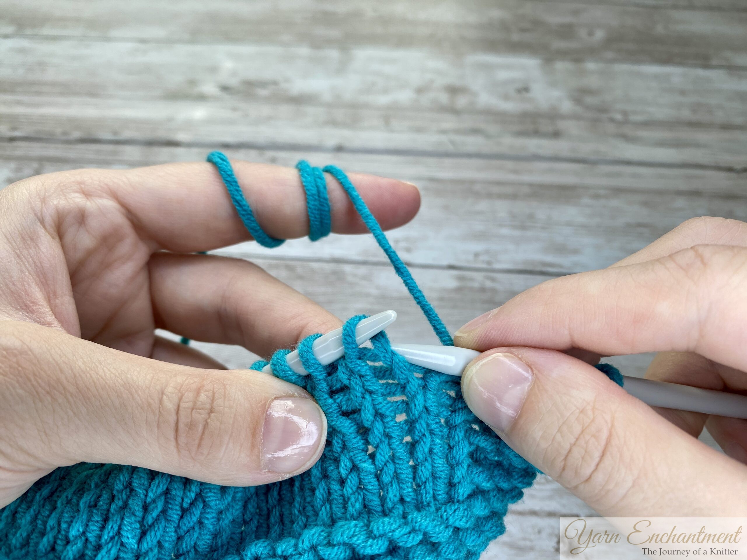 Close-up of a reverse mounted stitch with the leading leg (the right leg) positioned at the back of the needle.