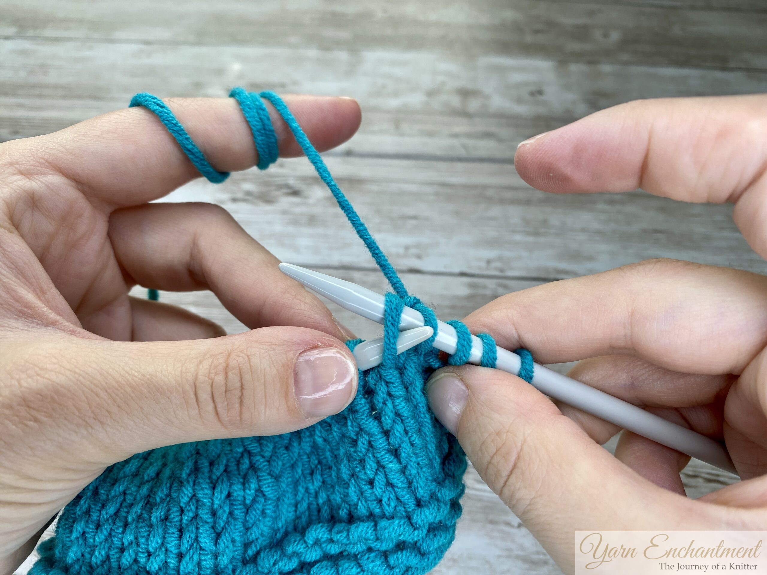 Close-up of hands knitting through the back loop of a stitch.