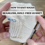 Close-up of a hand-knitted sock in cream-colored yarn, showing neatly picked-up gusset stitches and decreases, with colorful double-pointed needles in place.