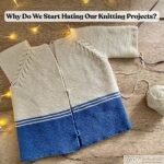 Unfinished hand-knitted cardigan in cream and blue yarn with circular needles, yarn ball, and fairy lights, illustrating knitting project frustration and the question ‘Why do we start hating our knitting projects?