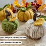 Four hand-knit pumpkins in cream, green, and yellow yarn, each with knitted leaves and curly stems, arranged on a light wooden table with wood slices and colorful autumn leaves in the background. Two lines of text read 'Simple Free Pumpkin Knitting Pattern' and 'Quick Autumn Decoration.