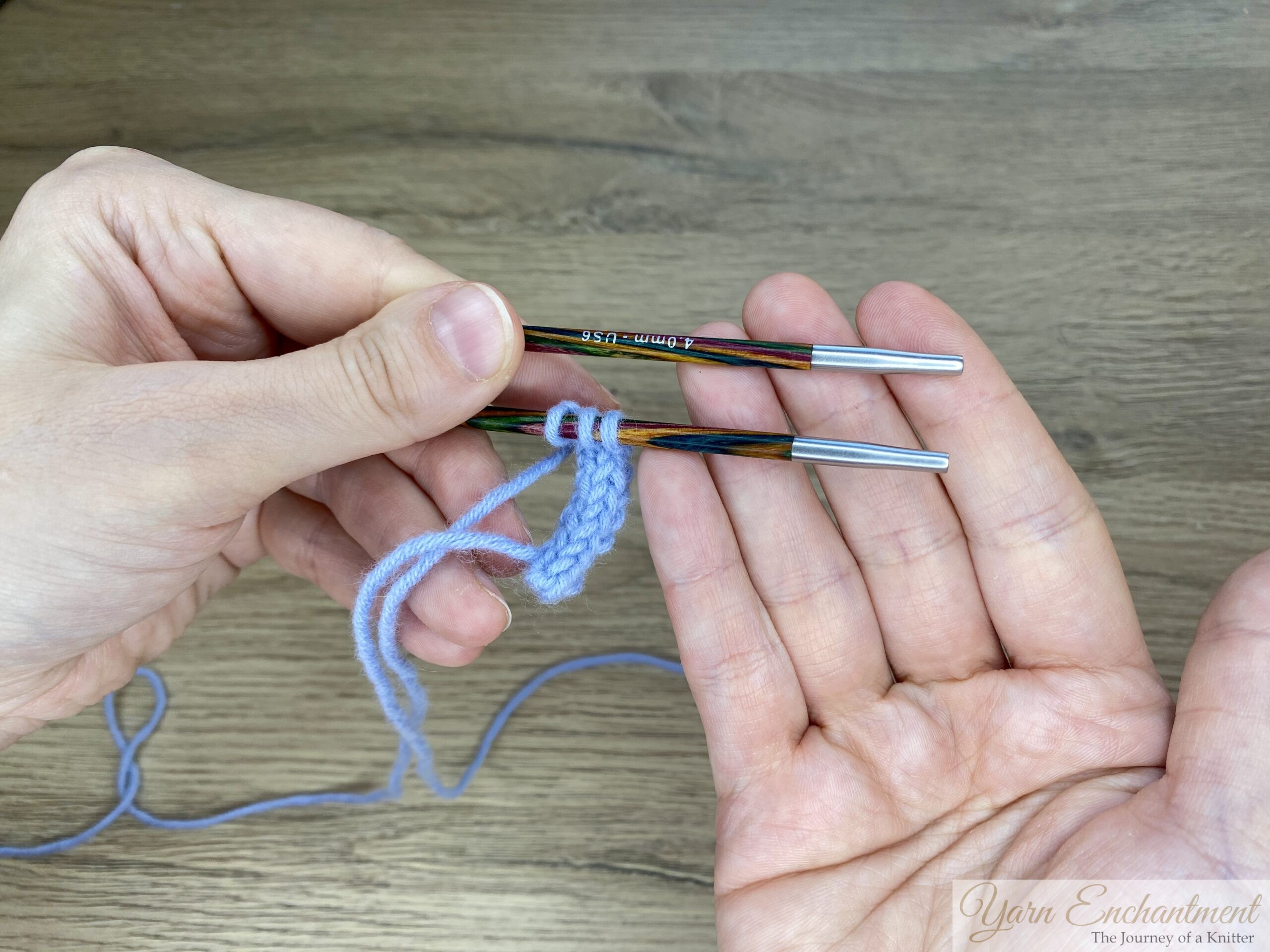 A demonstration of knitting I-cord using the tips of interchangeable needles. The images show blue yarn with stitches distributed along colorful needle tips, step by step, illustrating how to slide the stitches from one tip to the other to continue knitting the I-cord.