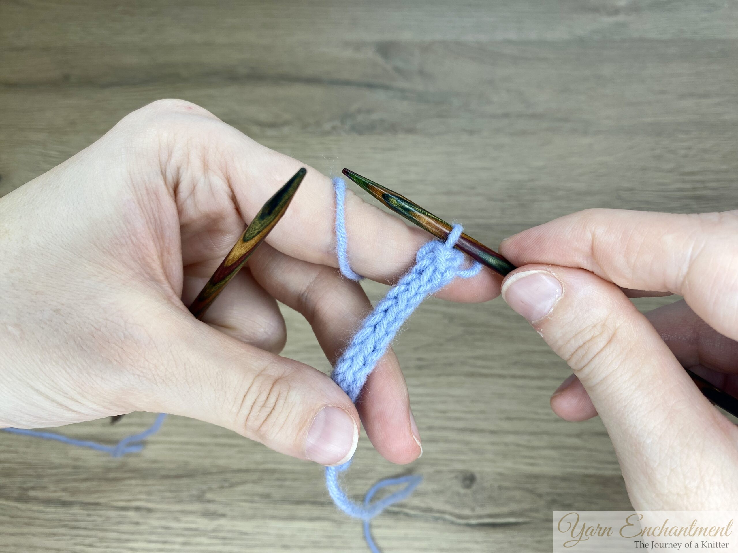 Completed I-cord with the yarn tail ready to be pulled through the last stitch, showing the finished and neatly bound-off end.