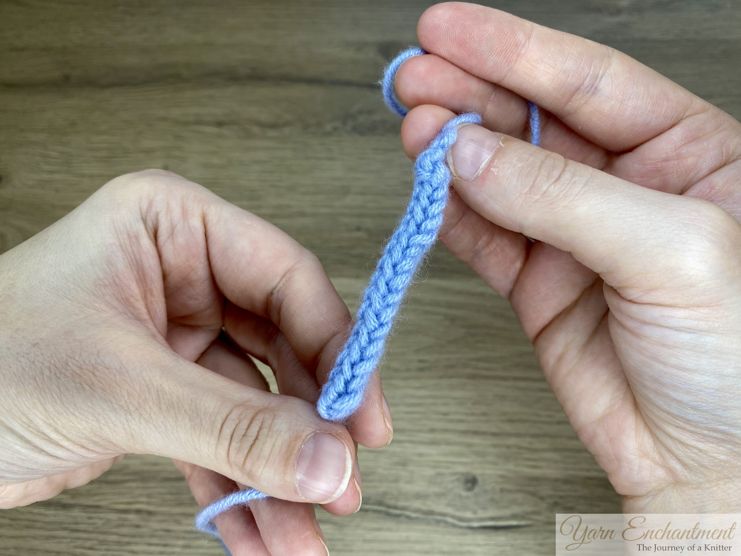 This is an I-cord shown in two stages: before rolling, where the stitches appear loose and the tube is not fully closed,