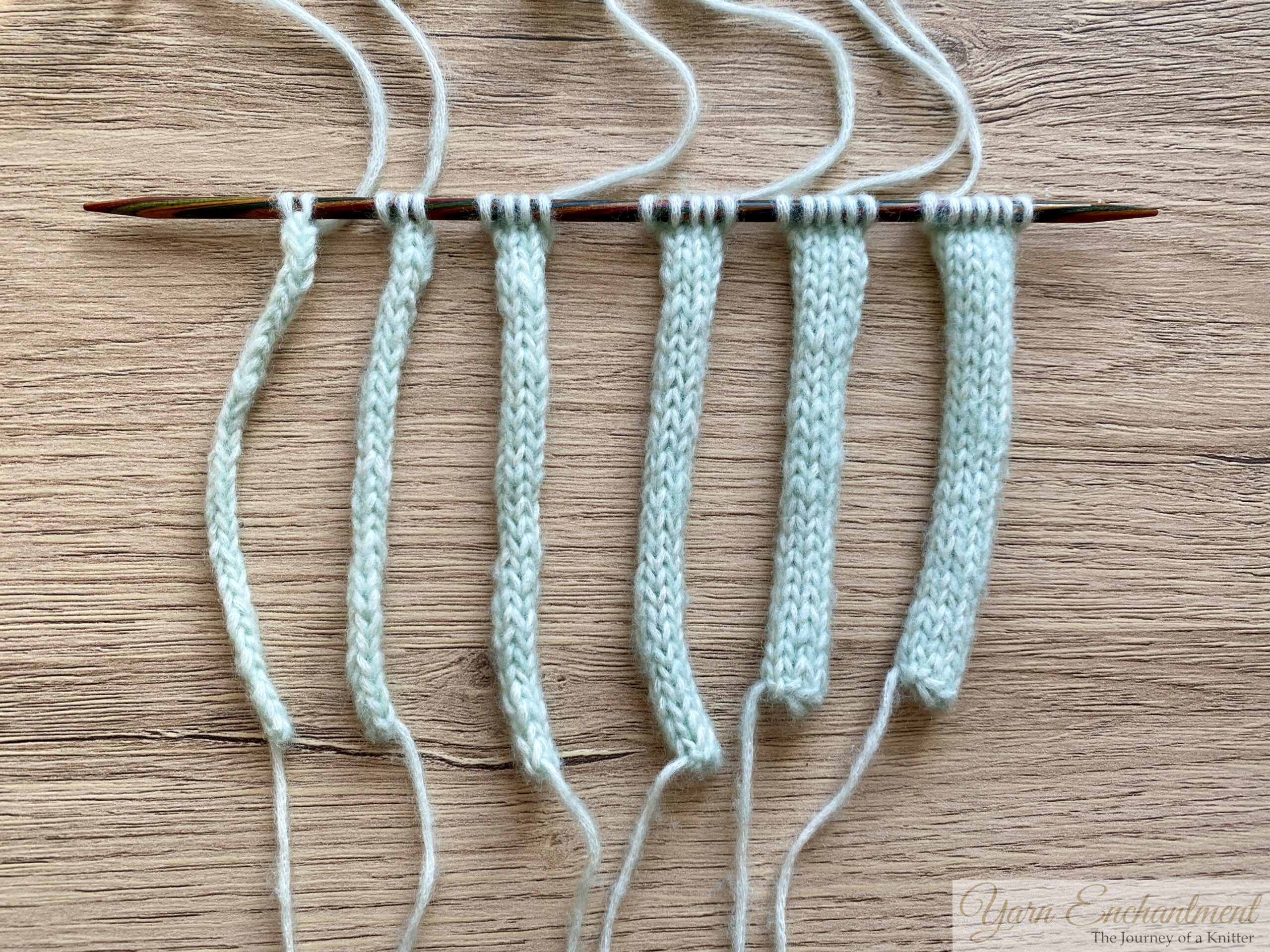 Knitting i-cord swatches with 2 to 7 stitches lined up on wooden needle