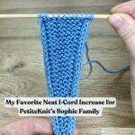 A close-up of a blue knitted Sophie-style scarf swatch with neat I-cord edges, held on wooden needles in a pair of hands, with overlaid text reading “My Favorite Neat I-Cord Increase for PetiteKnit’s Sophie Family”