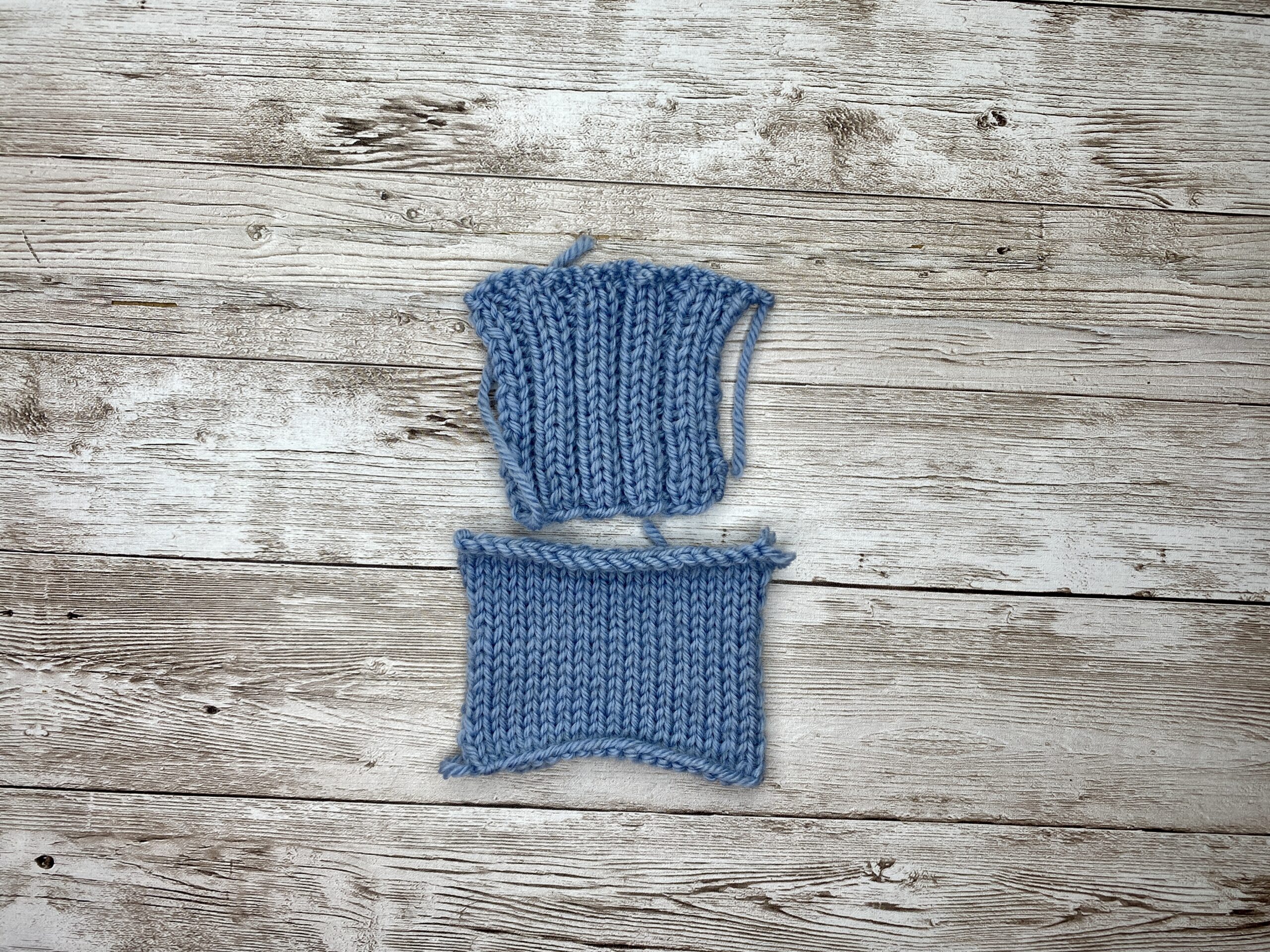 Blue ribbed borderless gauge swatch stacked with a blue rib swatch that has garter borders.