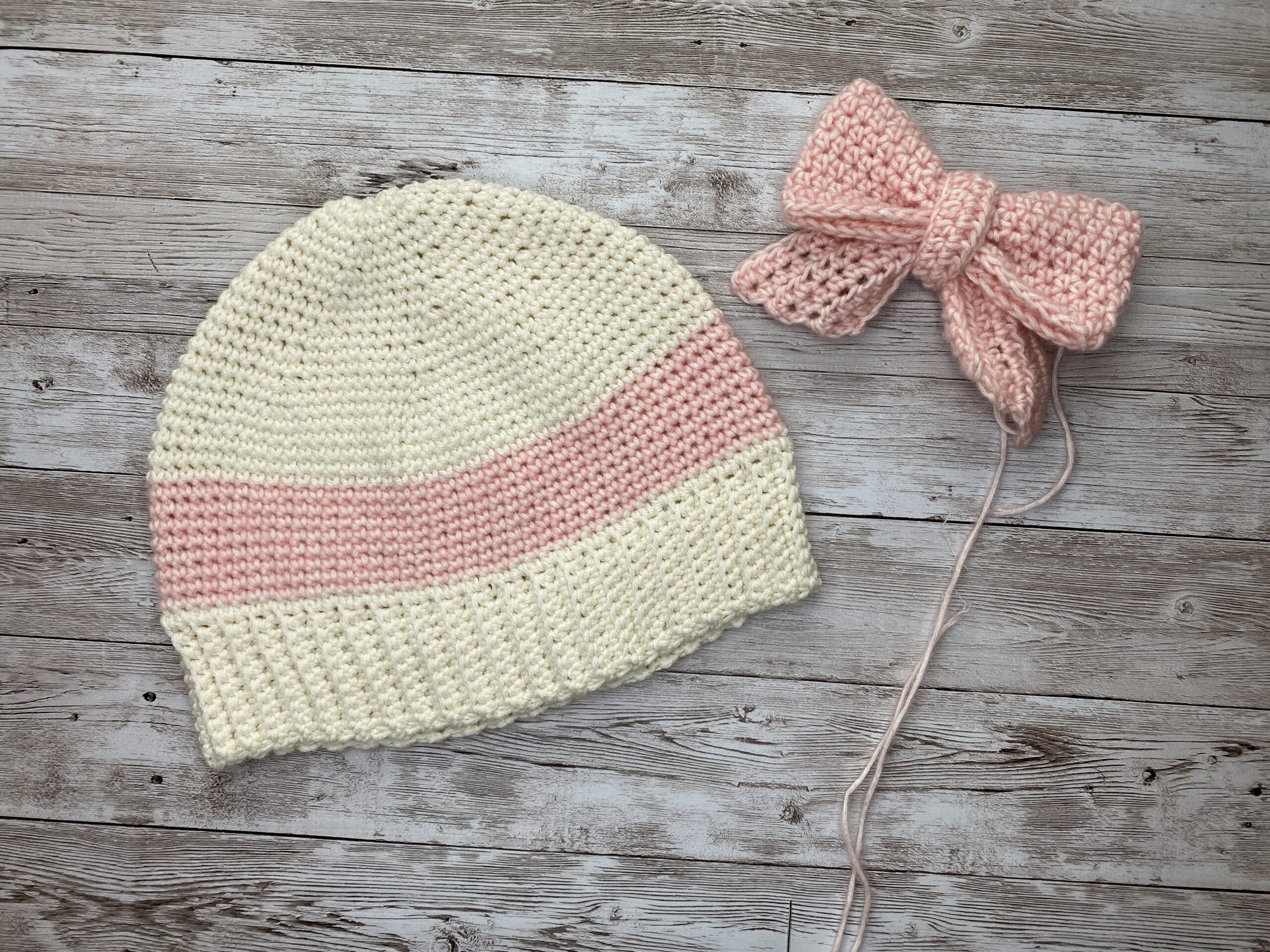 blushbow Beanie – cream and blush crochet hat with an oversized bow, handmade as a special gift from mother to daughter.