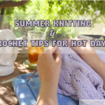 Close-up of hands knitting a light purple lace summer top outdoors. A white portable desk fan and a glass of iced tea sit on a wooden table in the sunny background, illustrating summer knitting and crochet tips for hot days.