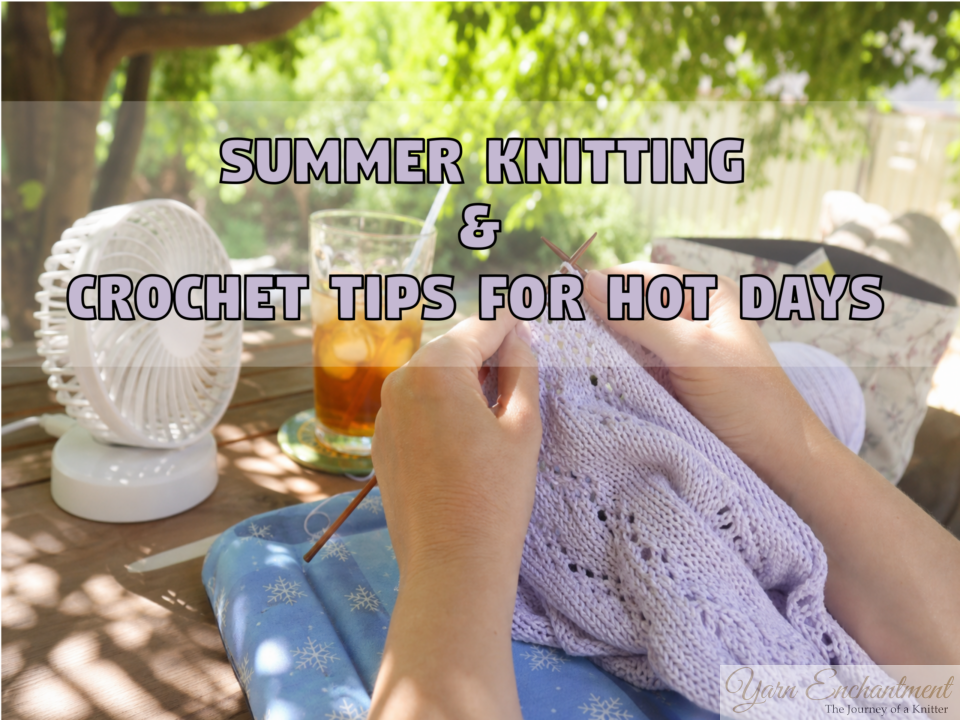 Close-up of hands knitting a light purple lace summer top outdoors. A white portable desk fan and a glass of iced tea sit on a wooden table in the sunny background, illustrating summer knitting and crochet tips for hot days.