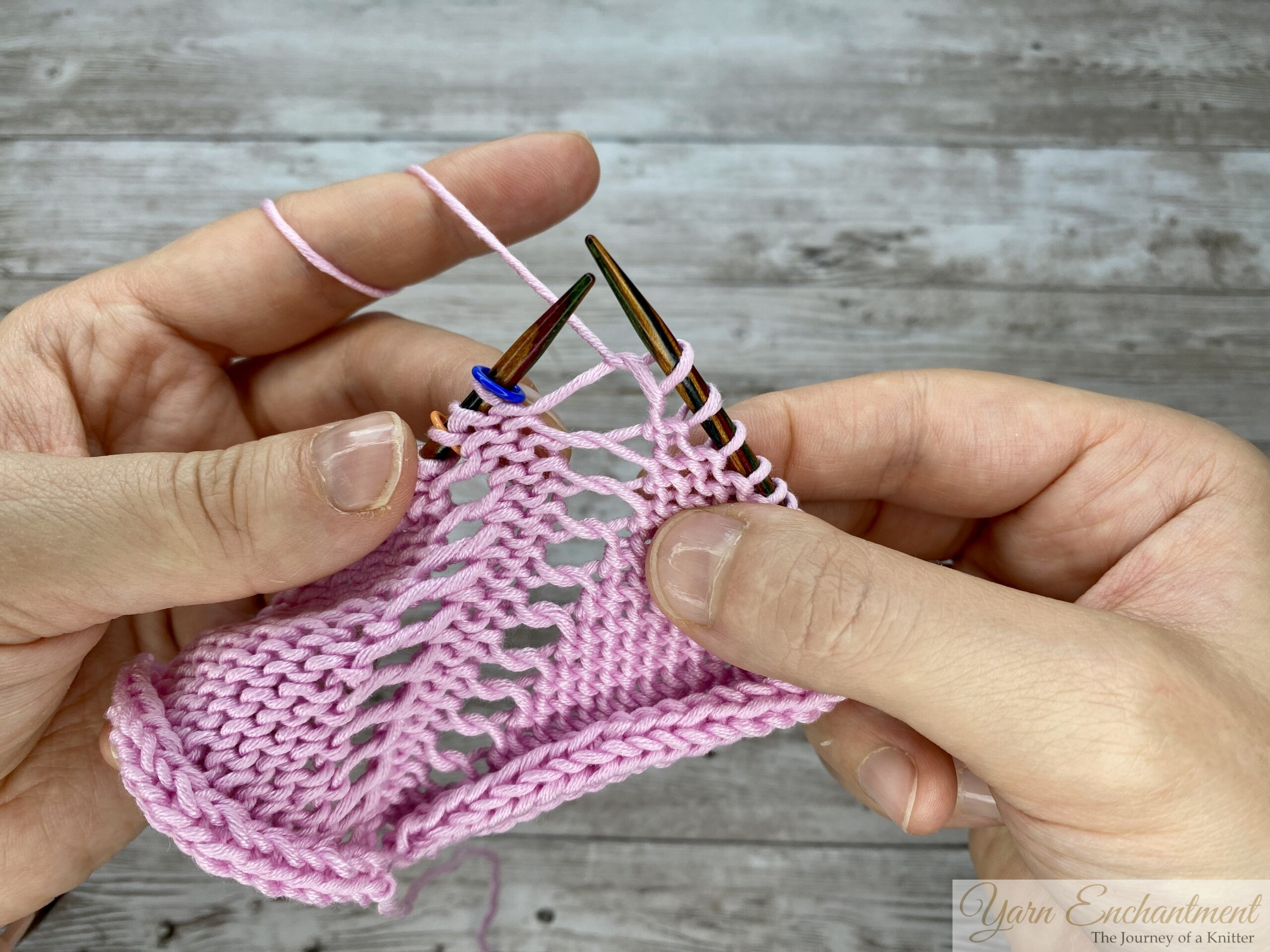 Laying the finished purl stitches flat to show the resulting decorative holes created by purling through the front loop on the wrong side