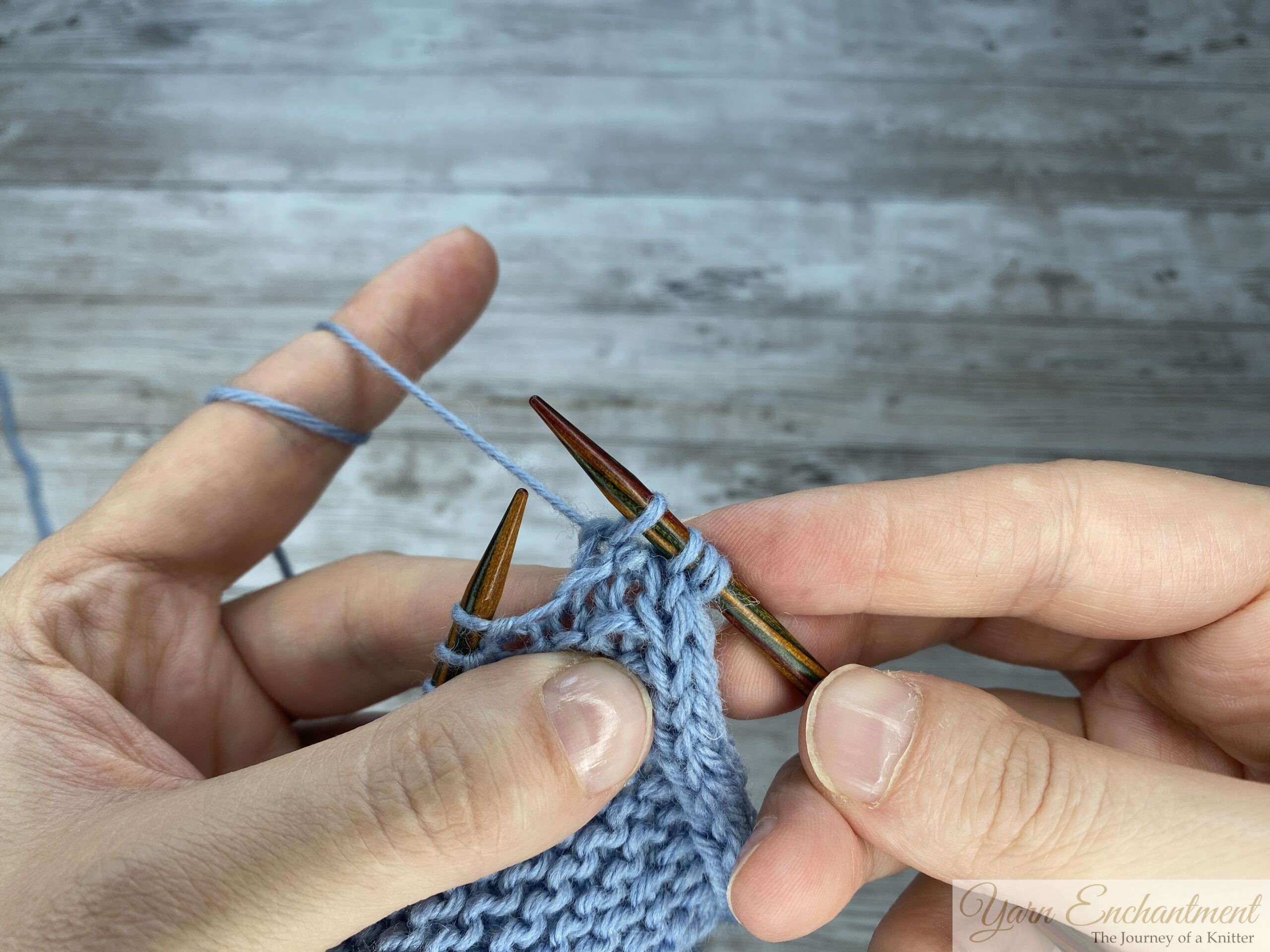 A three-part close-up sequence showing hands working a decrease stitch on a light blue knitted Sophie scarf. The photos show the right-hand needle inserting into stitches, wrapping the yarn, and pulling the new loop through to complete the decrease.
