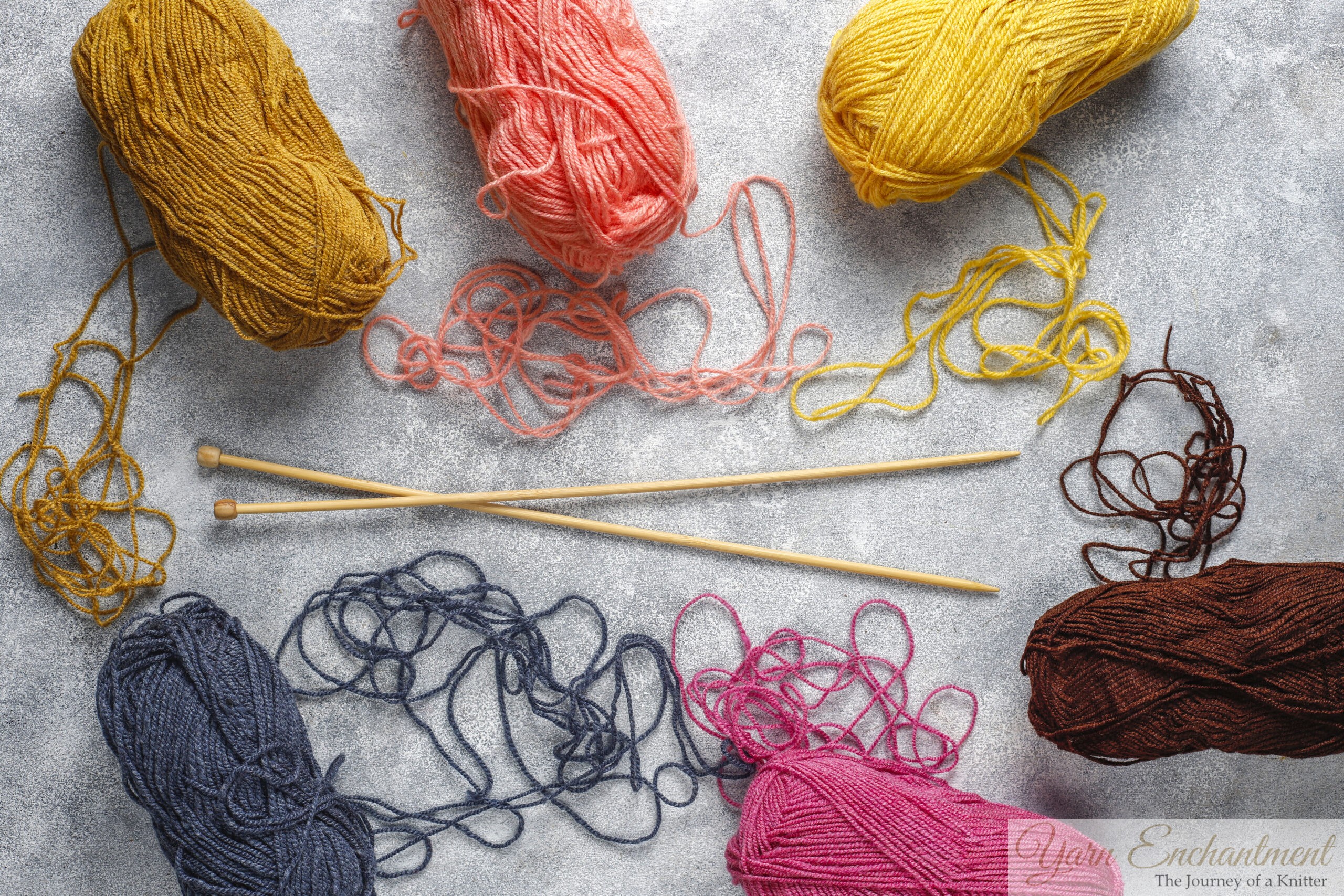 A flat lay of tangled colorful yarn with wooden knitting needles, representing an anxious mind trying to knit.