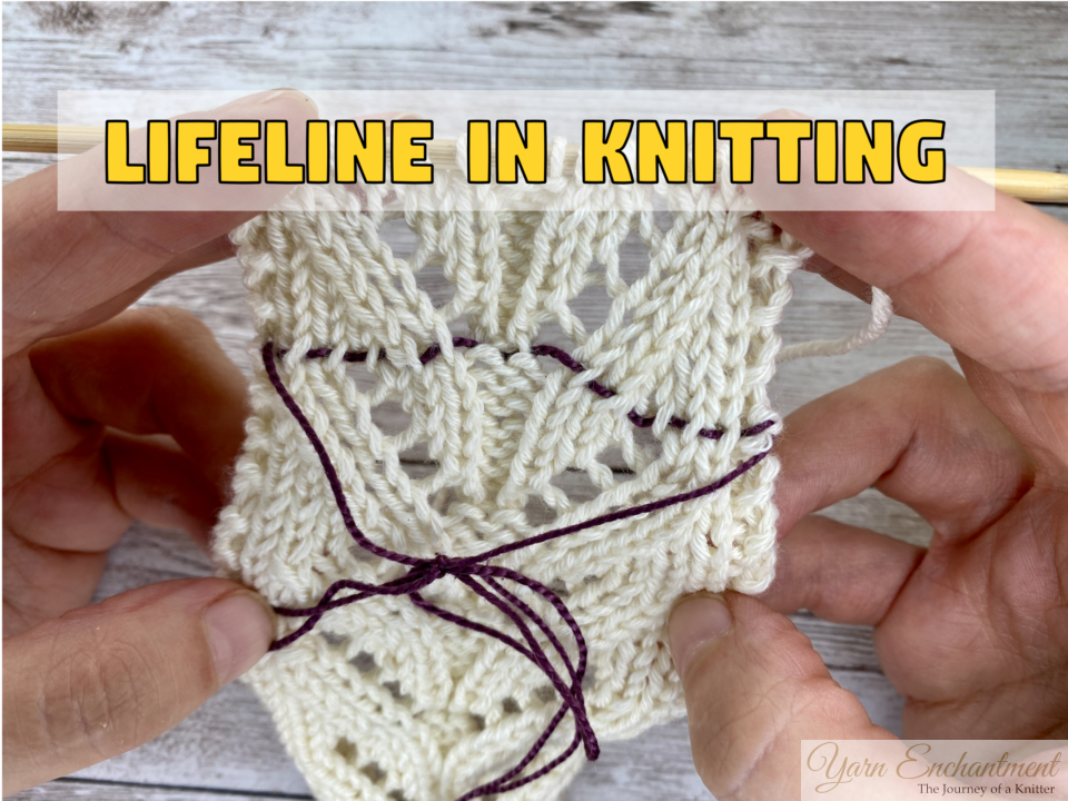 Hands stretch an ivory lace swatch to show a plum contrast lifeline threaded through one row of stitches, knotted below