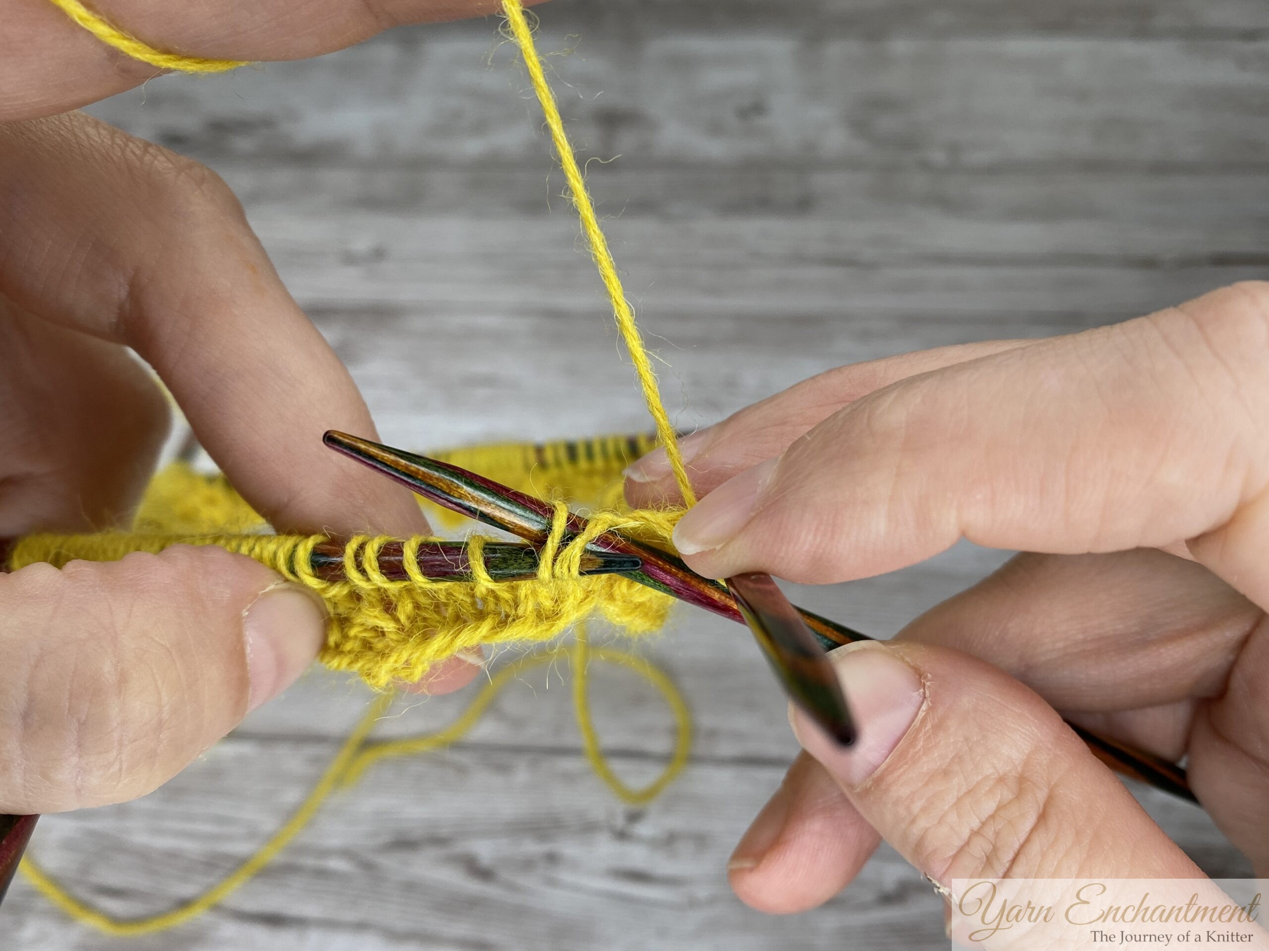 Right needle inserted into two slipped stitches to work an SSK on the ruffle sock cuff