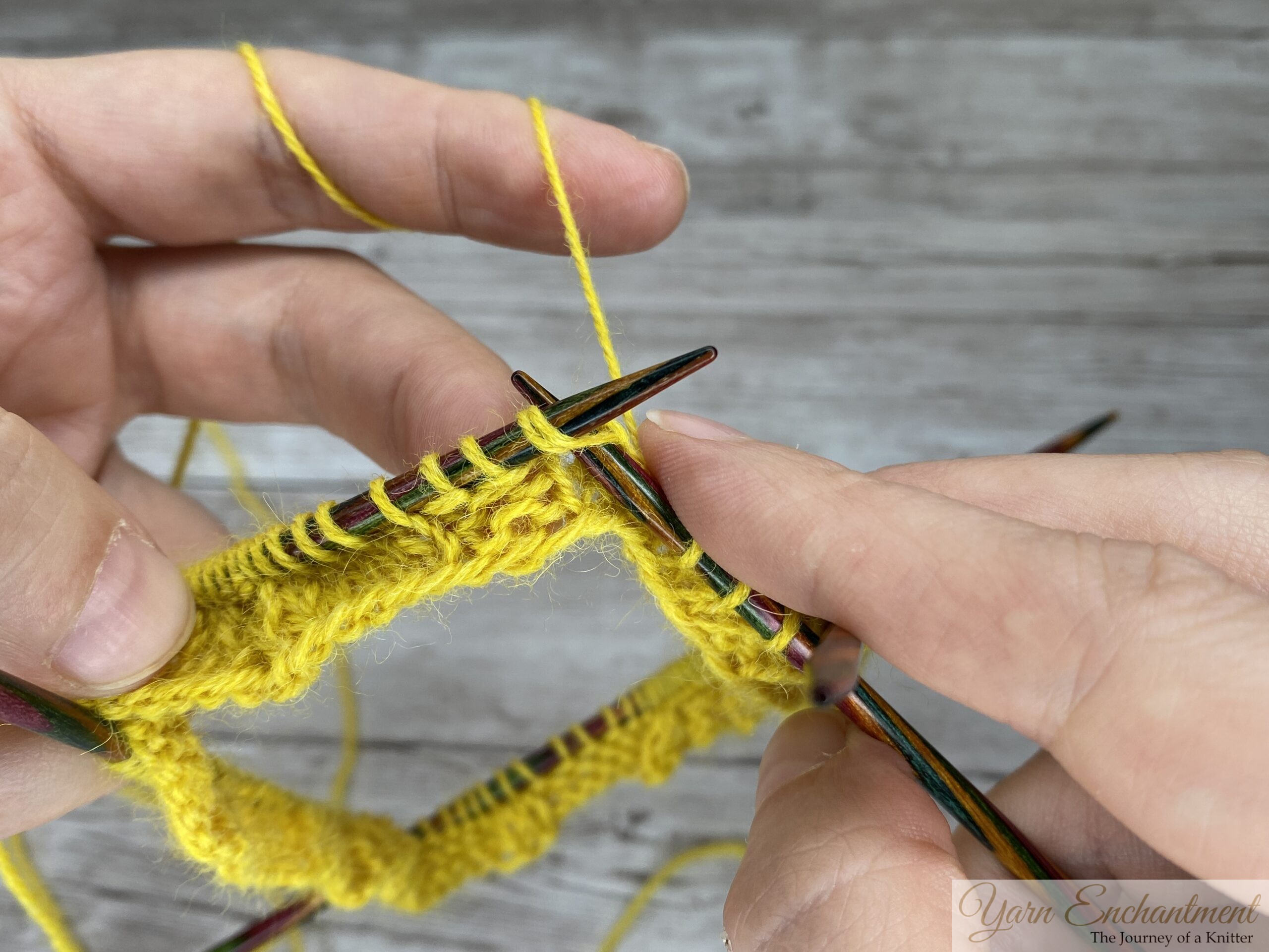 K2tog on the ruffle sock cuff, right needle inserted through two front-facing stitches in yellow sock yarn