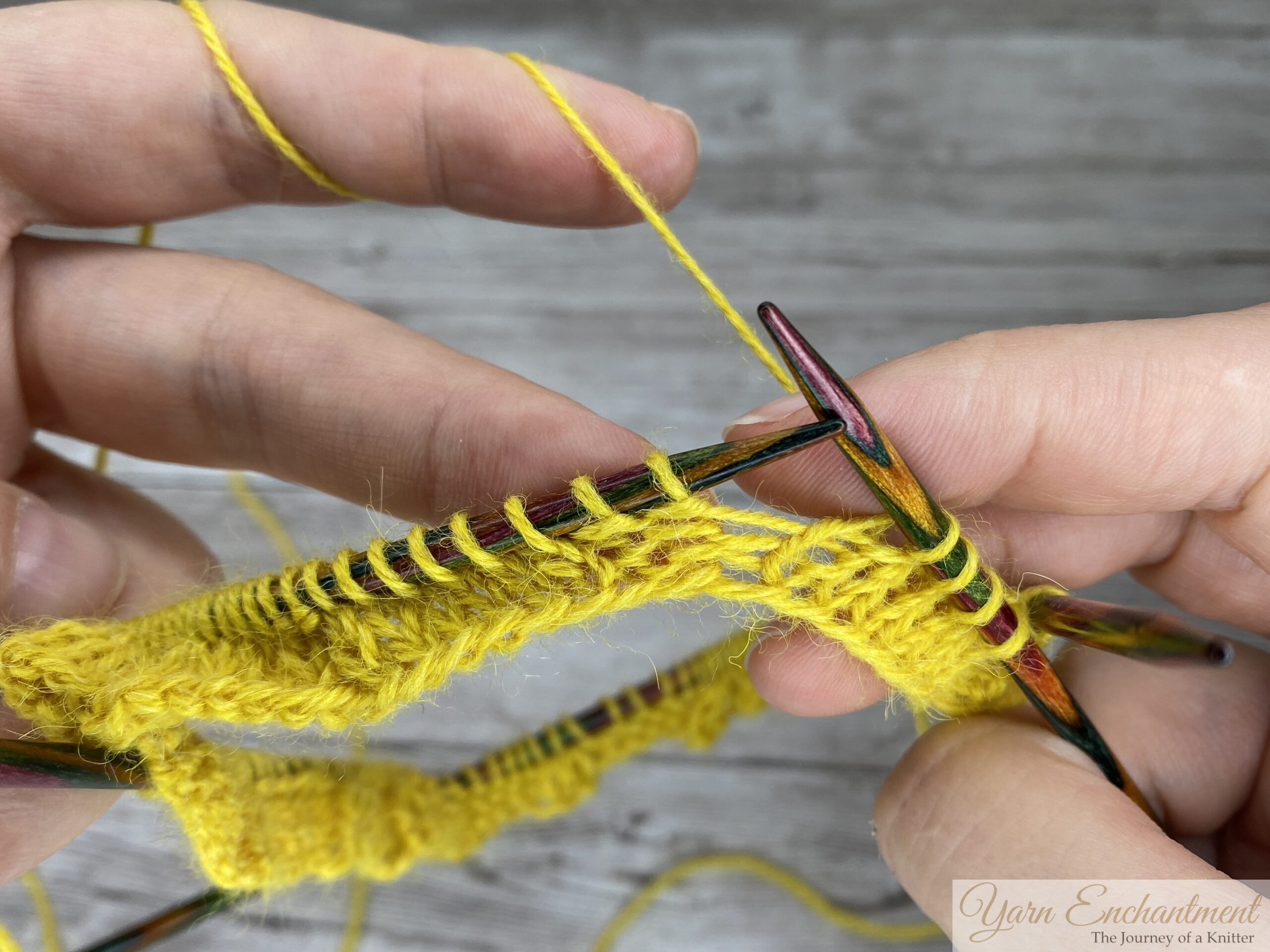 yellow yarn showing two purl stitches