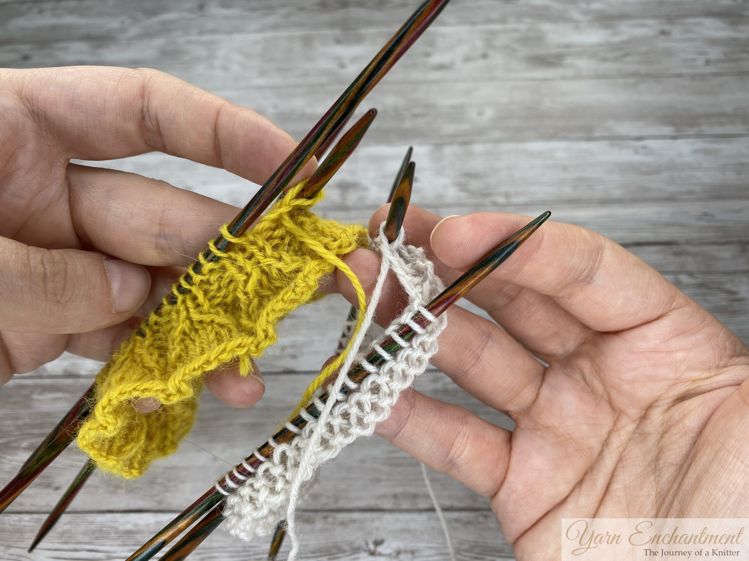 A flat lay view of a knitting project resting on colorful